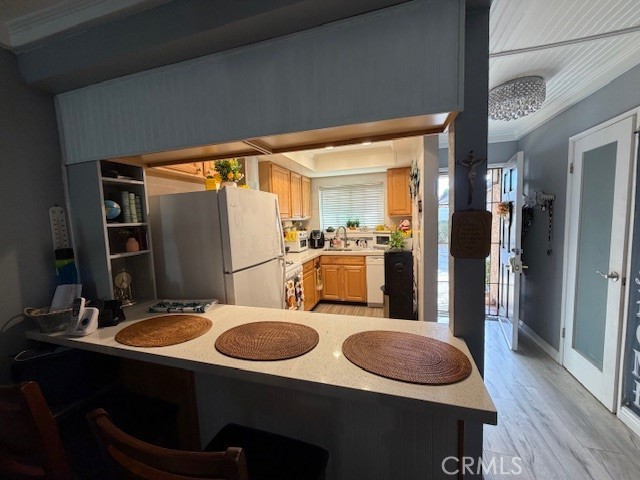 708 West Lambert Road, Unit 6 La Habra, CA 90631 - Photo 4 of 13 a kitchen with sink refrigerator dining table and chairs