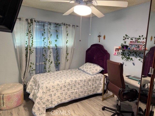 708 West Lambert Road, Unit 6 La Habra, CA 90631 - Photo 7 of 13 a bedroom with a bed and a chandelier