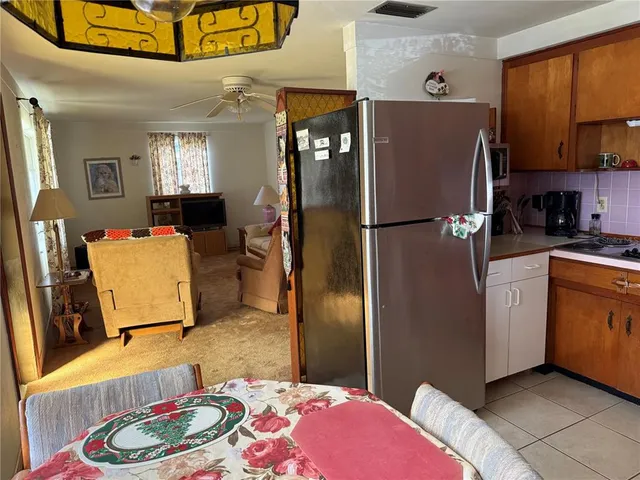a living room with furniture a ceiling fan and a window
