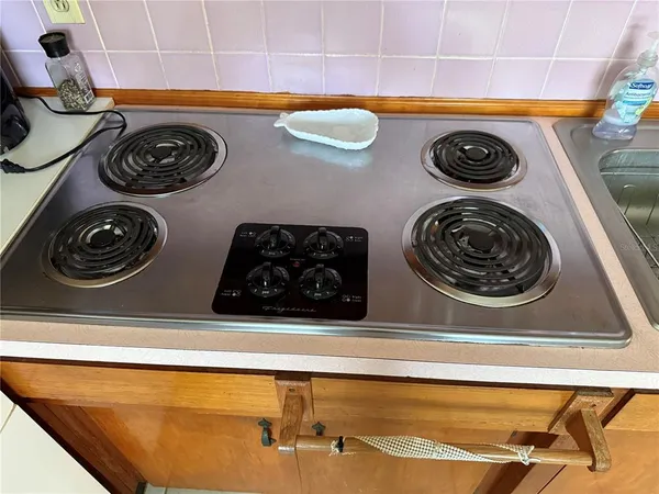 a close up view of a stove and a sink