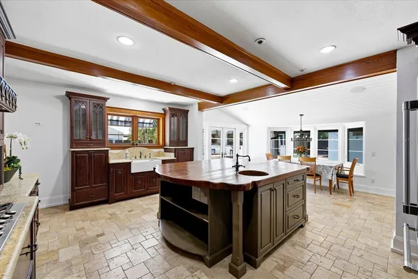 a dining room with furniture a rug and a large window