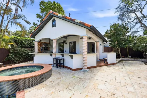 a view of a house with backyard porch and sitting area