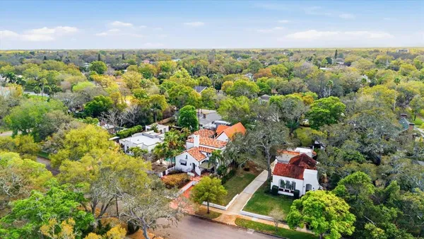 an aerial view of residential houses with outdoor space