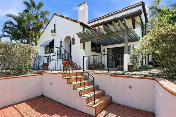 a front view of a house with a potted plant