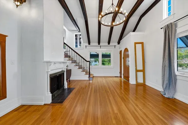 a view of a livingroom with furniture staircase and a fireplace