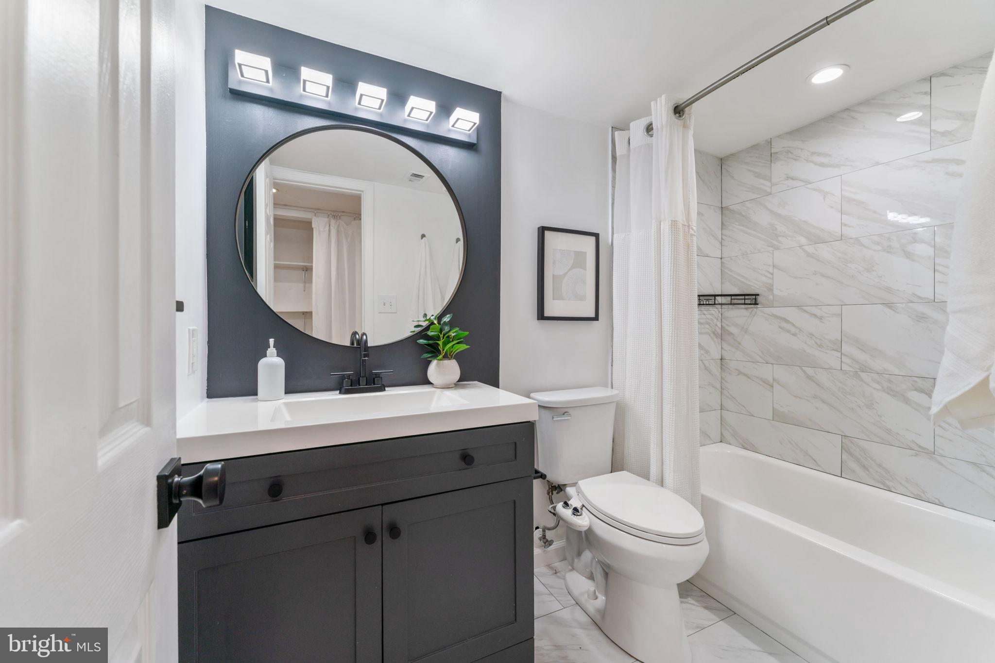 1700 17th Street Northwest, Unit 508 Washington, DC 20009 - Photo 13 of 24 a bathroom with a toilet a sink and a bathtub