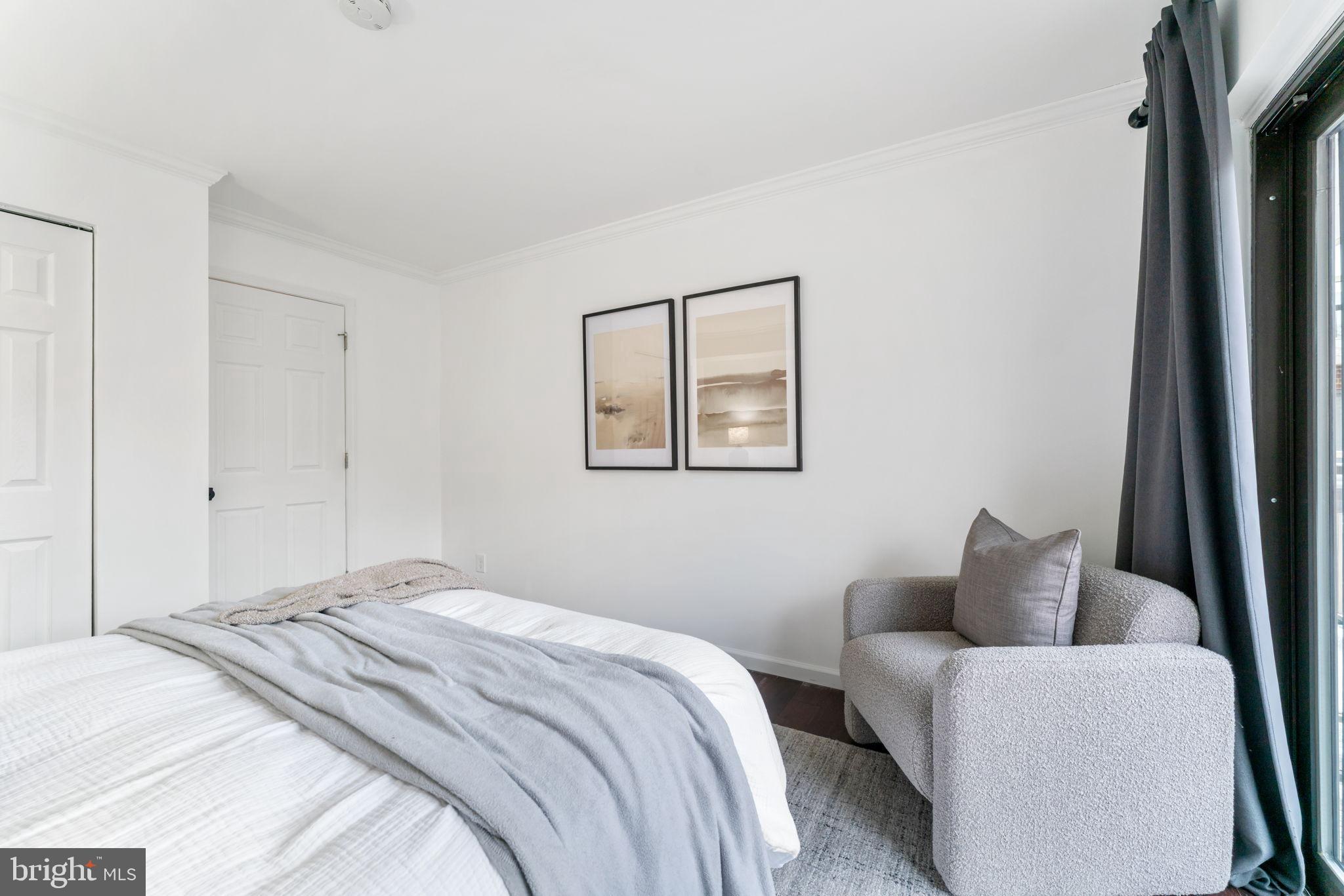 1700 17th Street Northwest, Unit 508 Washington, DC 20009 - Photo 16 of 24 a bedroom with a bed and a couch