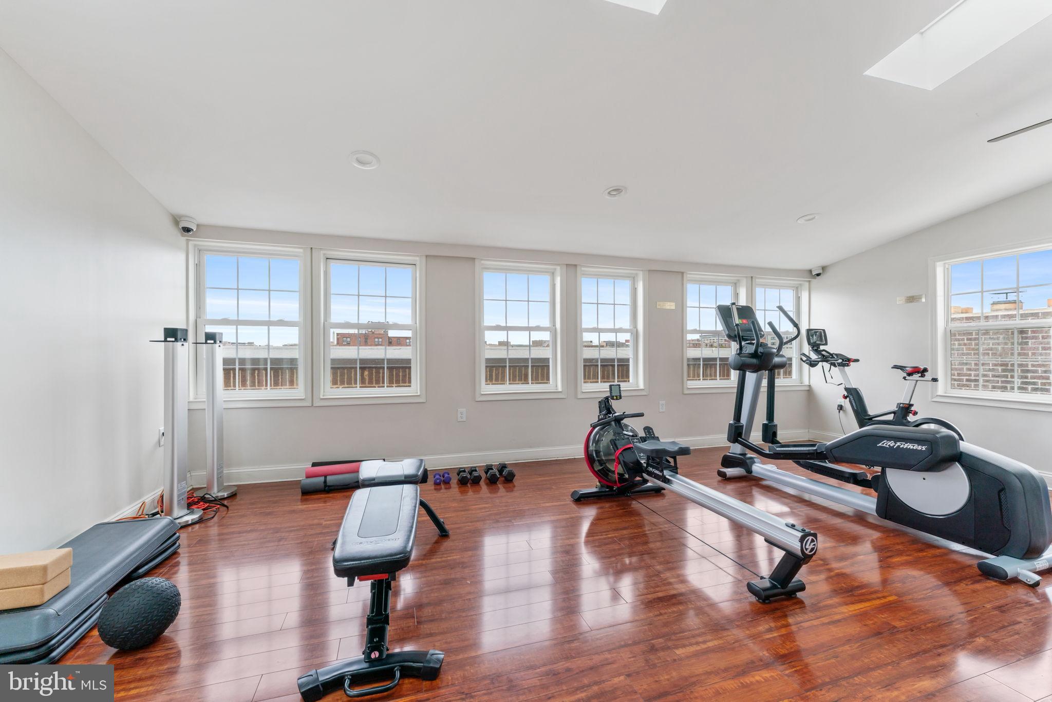 1700 17th Street Northwest, Unit 508 Washington, DC 20009 - Photo 22 of 24 a room with gym equipment equipment wooden floor and windows
