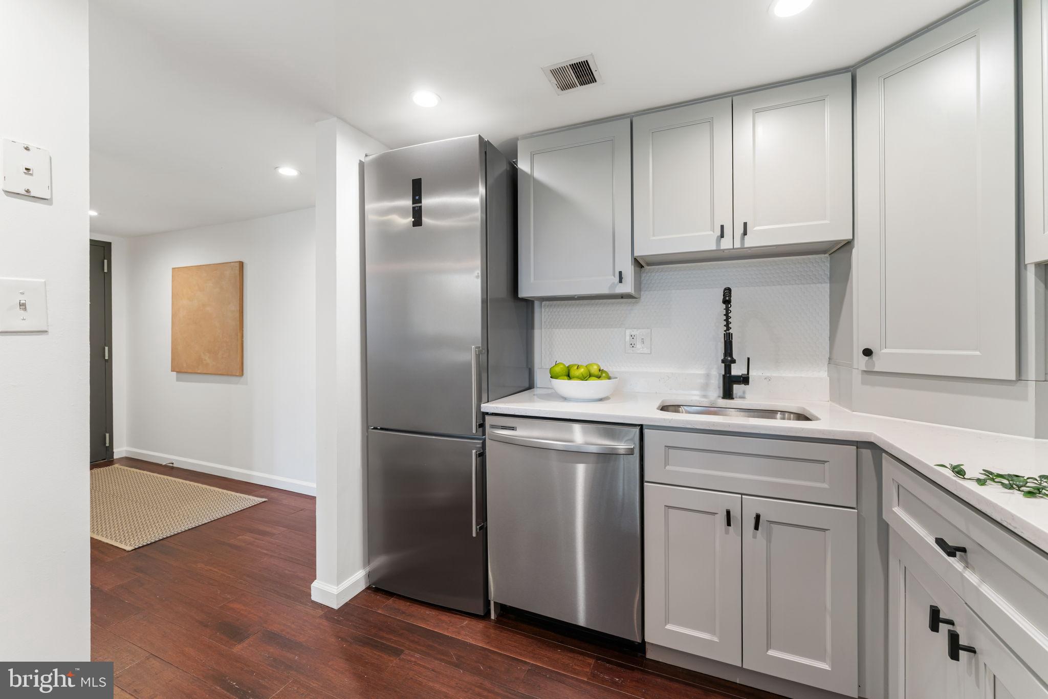 1700 17th Street Northwest, Unit 508 Washington, DC 20009 - Photo 5 of 24 a kitchen with cabinets and stainless steel appliances
