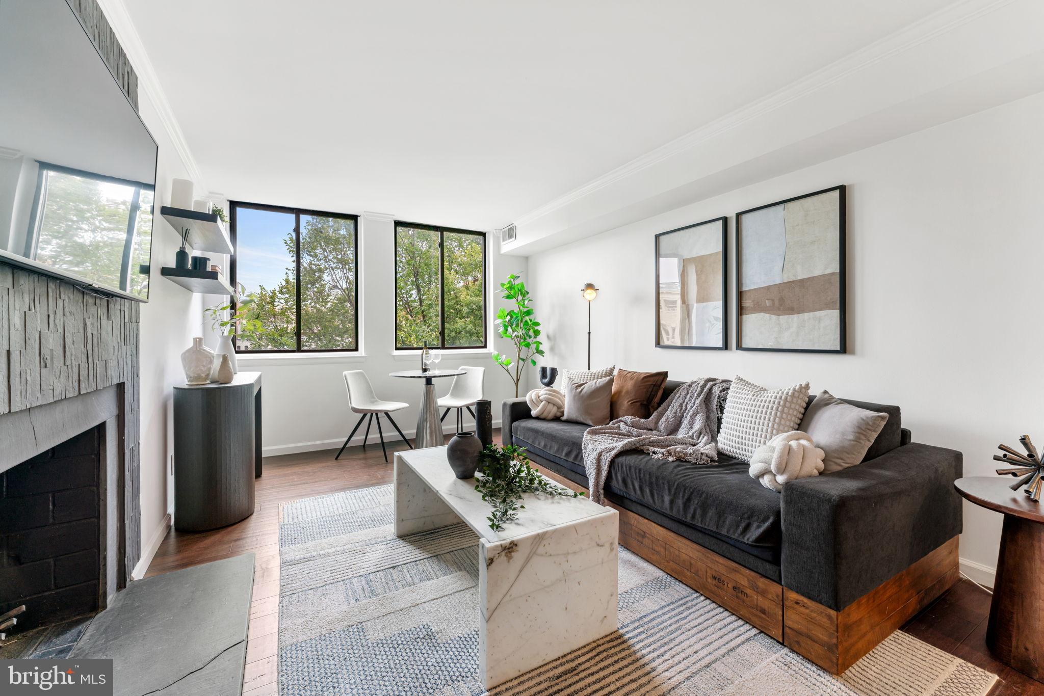 1700 17th Street Northwest, Unit 508 Washington, DC 20009 - Photo 10 of 24 a living room with furniture and a fireplace