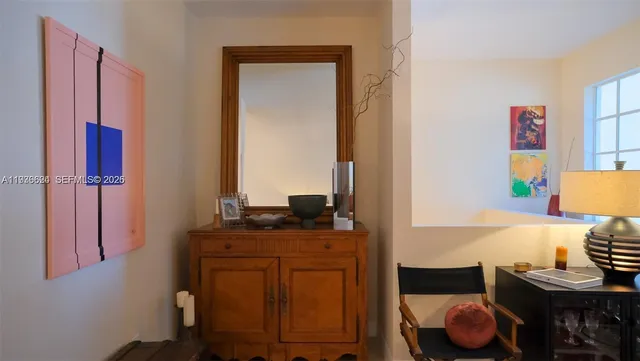 a living room with furniture a chandelier and a window