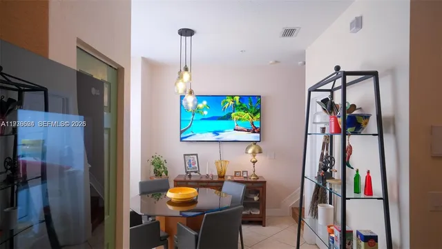 a living room with furniture and a mirror