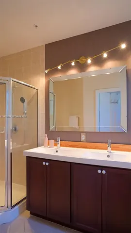 a bathroom with a sink and a painting on the wall