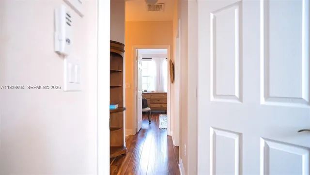 a view of hallway with wooden floor
