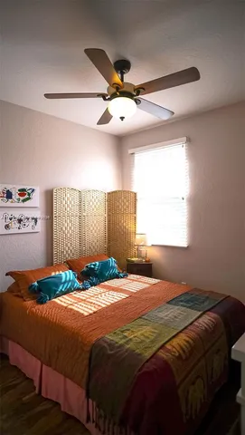 a view of a swimming pool with lawn chairs under an umbrella