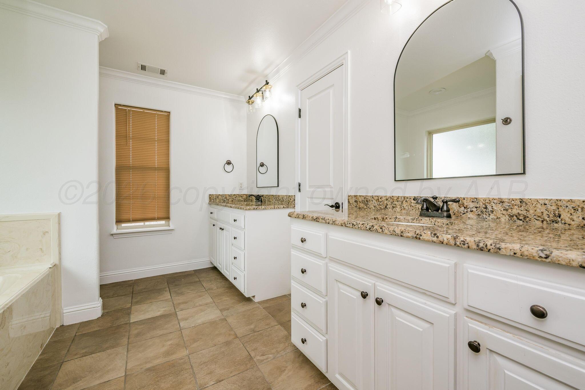 16700 Dove Meadow Road Canyon, TX 79015 - Photo 11 of 24 a bathroom with a sink a vanity and a mirror