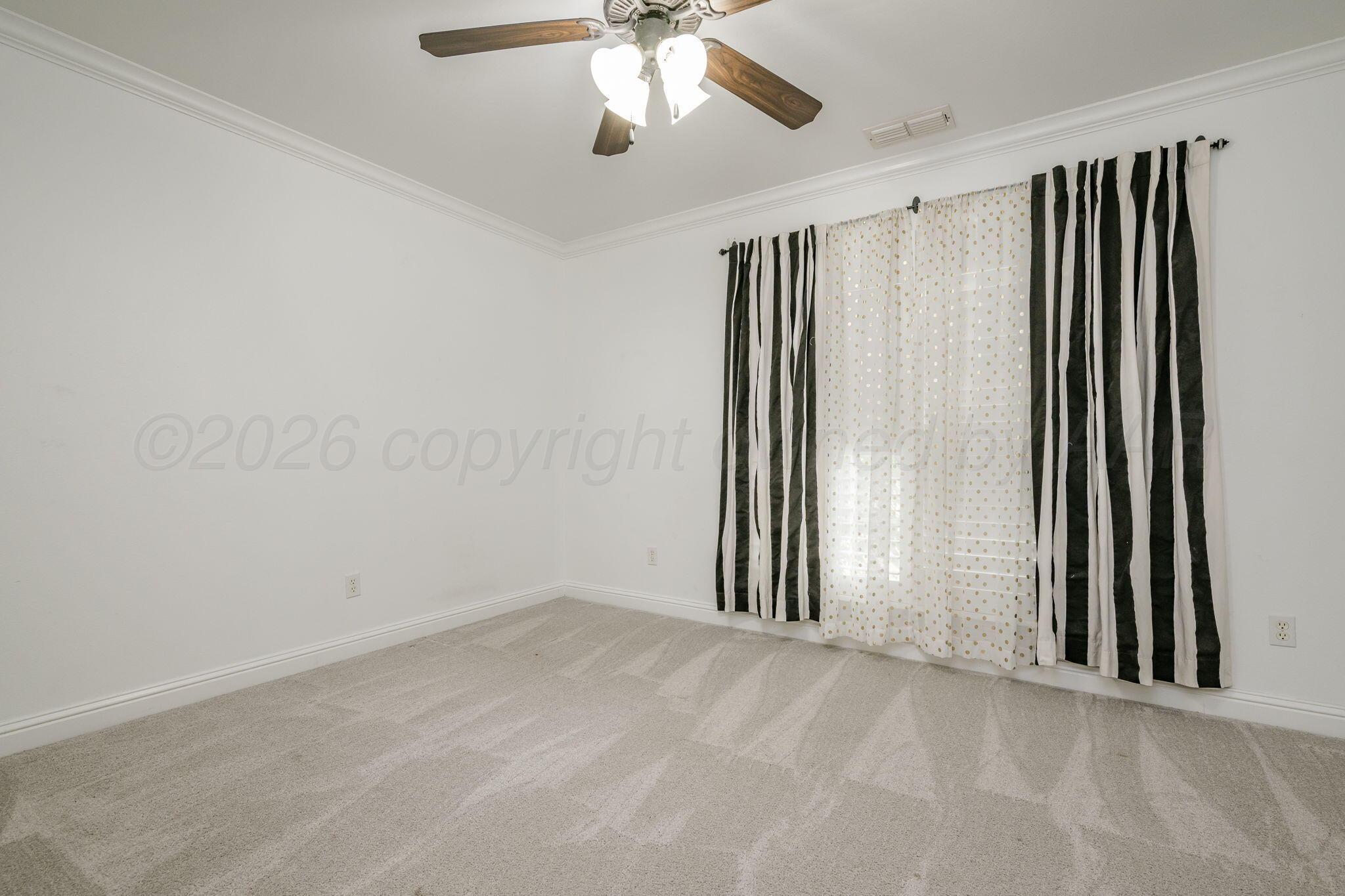 16700 Dove Meadow Road Canyon, TX 79015 - Photo 13 of 24 an empty room with windows and fan