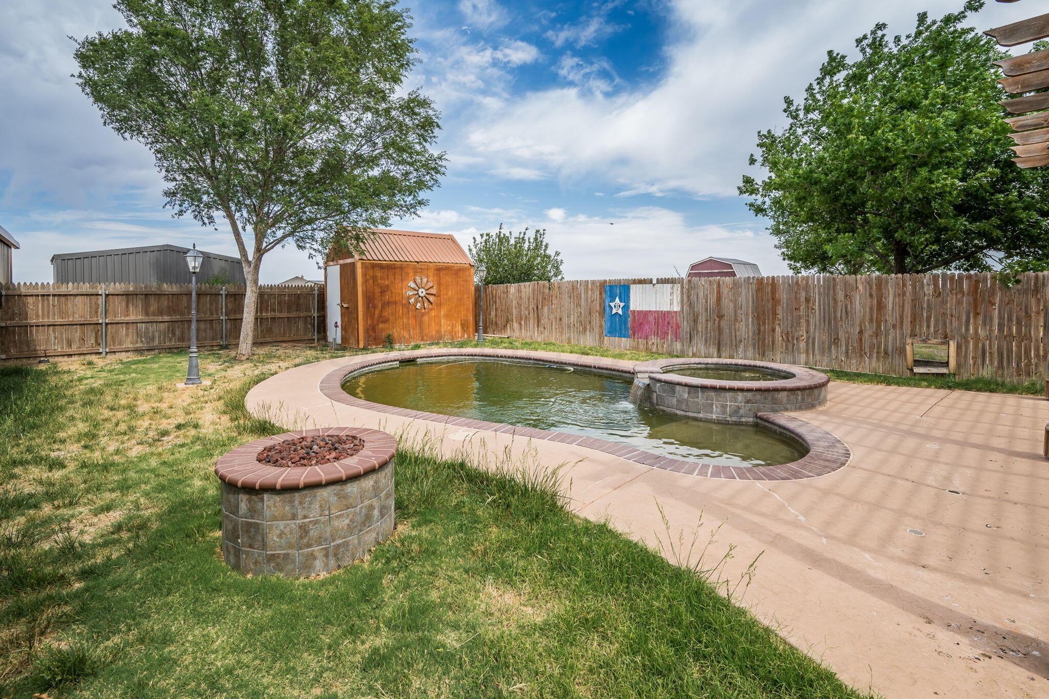 16700 Dove Meadow Road Canyon, TX 79015 - Photo 19 of 24 a view of a back yard of the house with a fountain