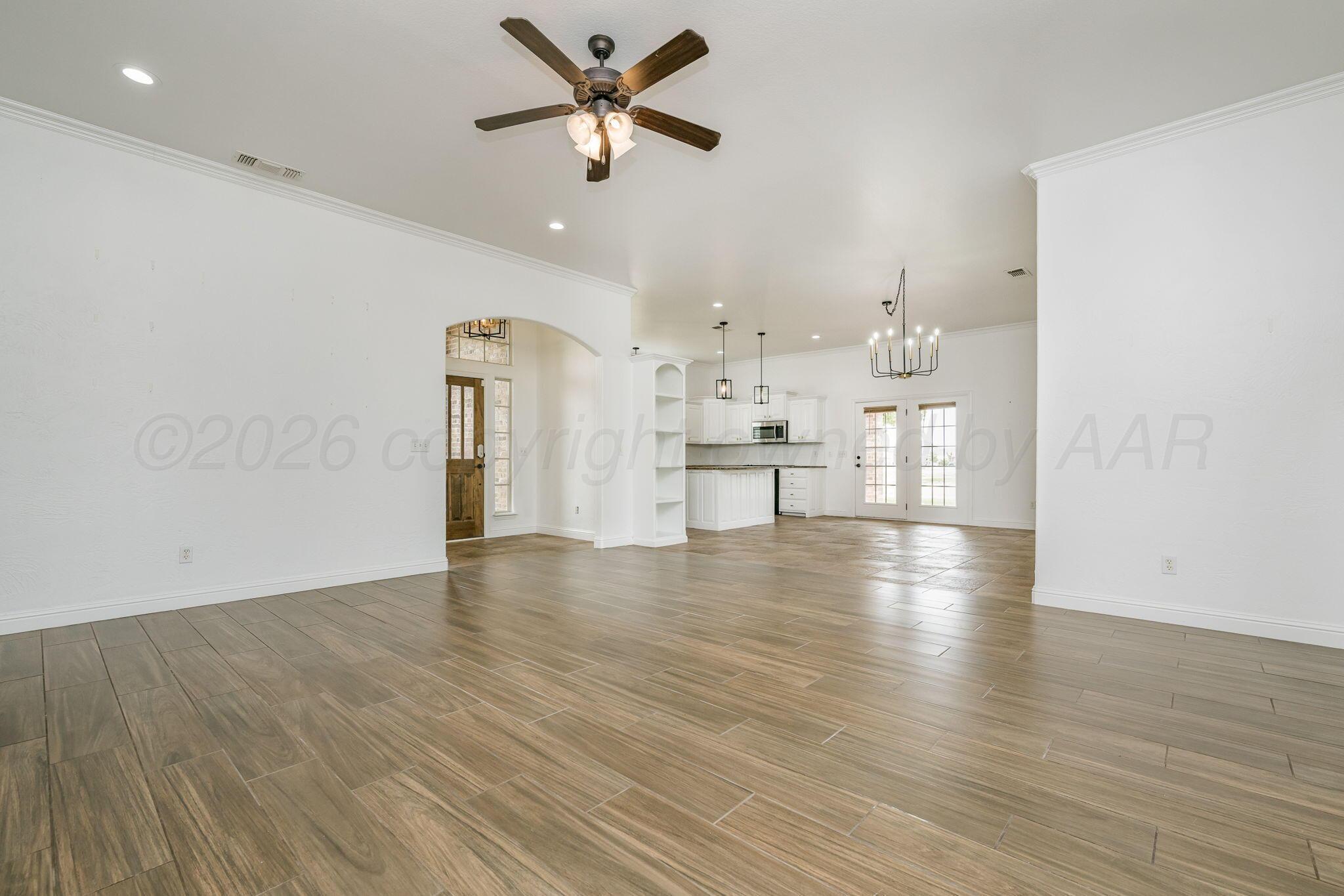 16700 Dove Meadow Road Canyon, TX 79015 - Photo 4 of 24 a view of a kitchen with wooden floor and a ceiling fan