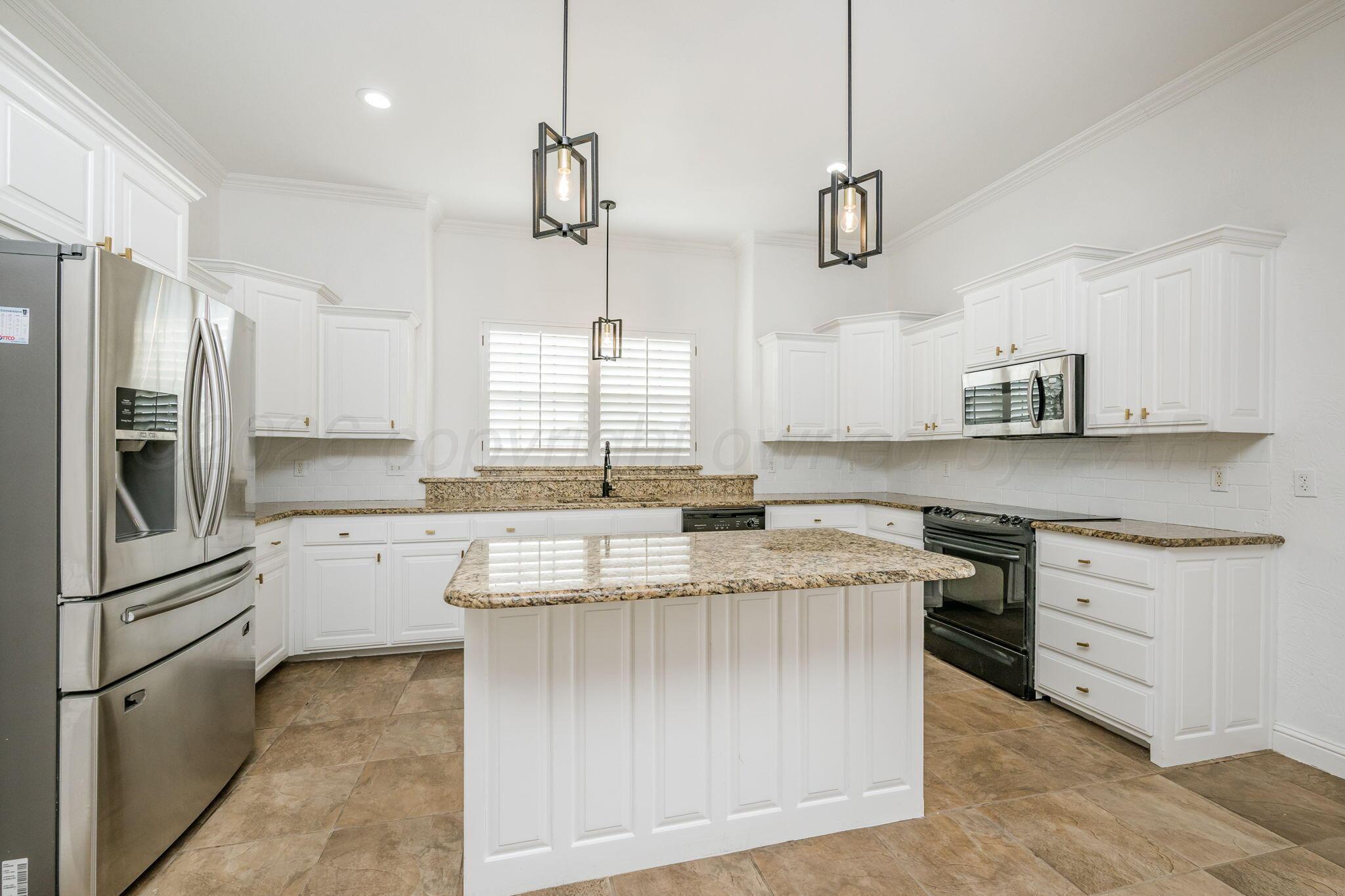 16700 Dove Meadow Road Canyon, TX 79015 - Photo 6 of 24 a kitchen with stainless steel appliances granite countertop a sink a stove and a refrigerator
