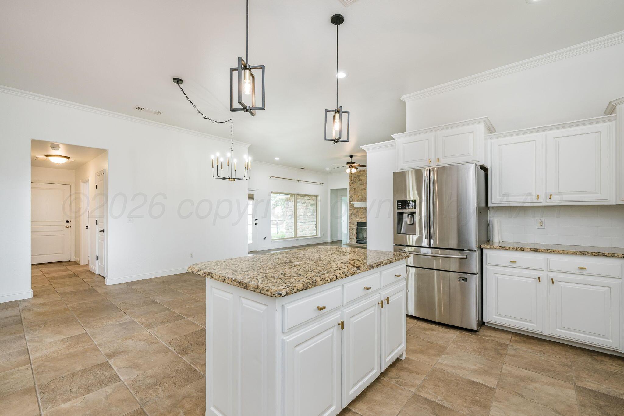 16700 Dove Meadow Road Canyon, TX 79015 - Photo 8 of 24 a kitchen with stainless steel appliances granite countertop a sink a refrigerator a stove and a granite counter tops