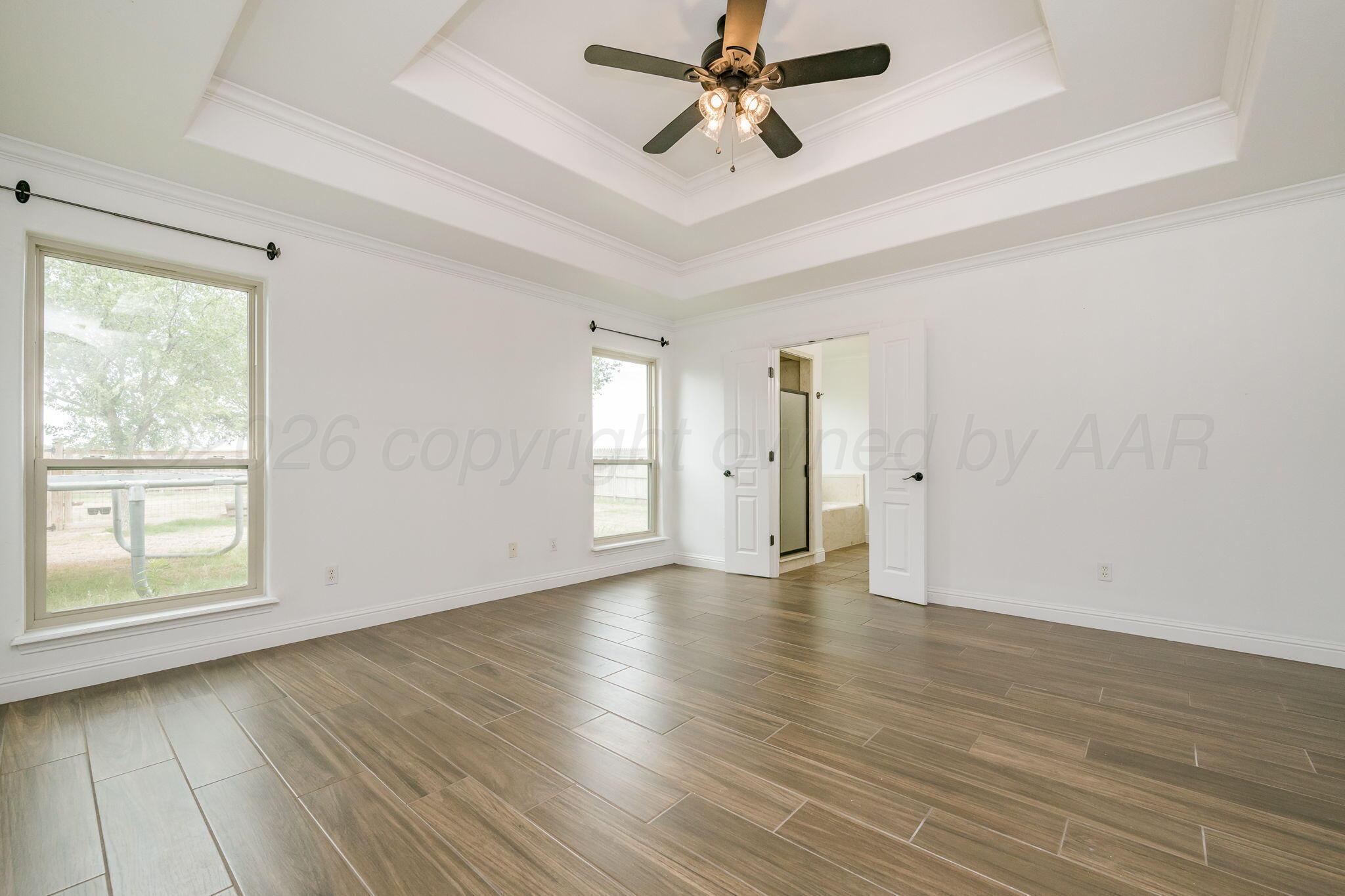 16700 Dove Meadow Road Canyon, TX 79015 - Photo 9 of 24 a view of empty room with wooden floor and fan