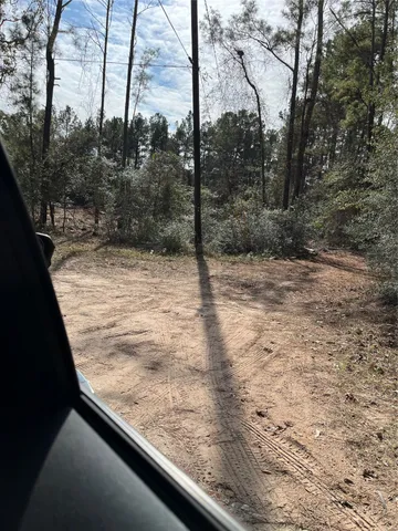 a view of a yard with wooden fence