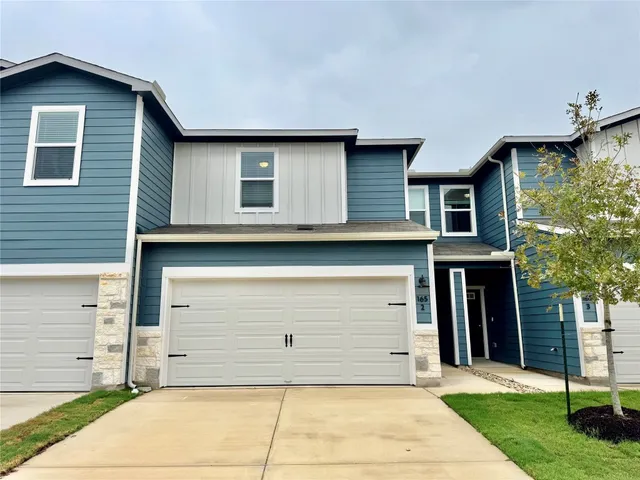 a view of a house with a backyard