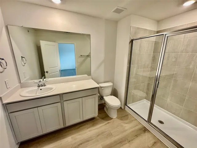 a bathroom with a sink a toilet and a mirror