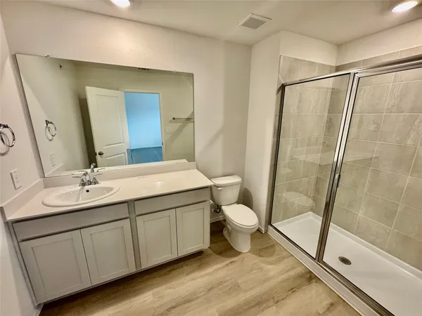 a bathroom with a sink a toilet and a mirror