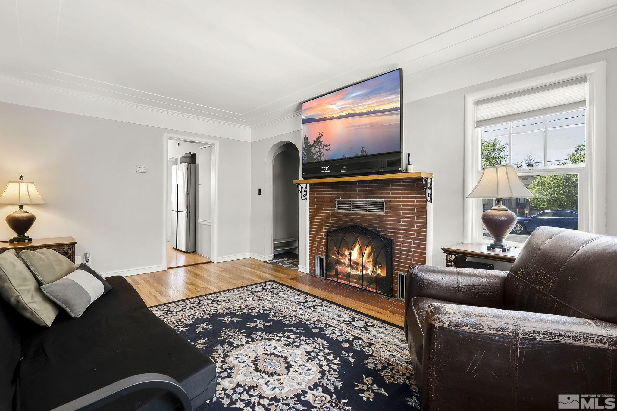 1124 Bon Rea Way Reno, NV 89503 - Photo 3 of 18 a living room with furniture a flat screen tv and a fireplace