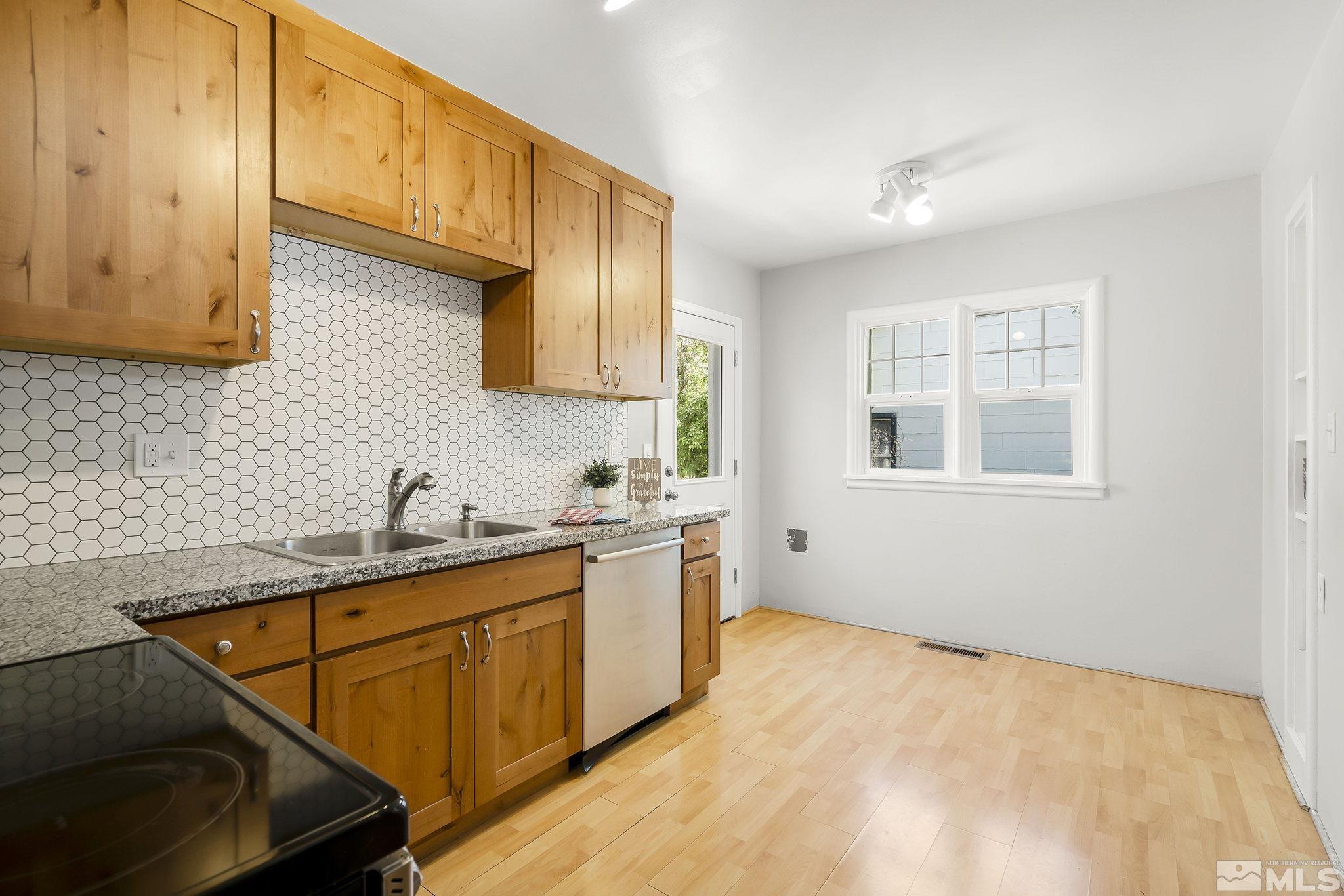 1124 Bon Rea Way Reno, NV 89503 - Photo 4 of 18 a kitchen with a sink stove and cabinets