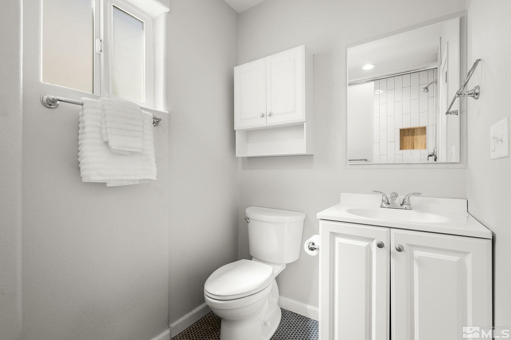 1124 Bon Rea Way Reno, NV 89503 - Photo 10 of 18 a bathroom with a toilet sink and mirror