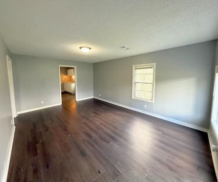 433 Dixie Road Memphis, TN 38109 - Photo 10 of 11 an empty room with wooden floor and windows
