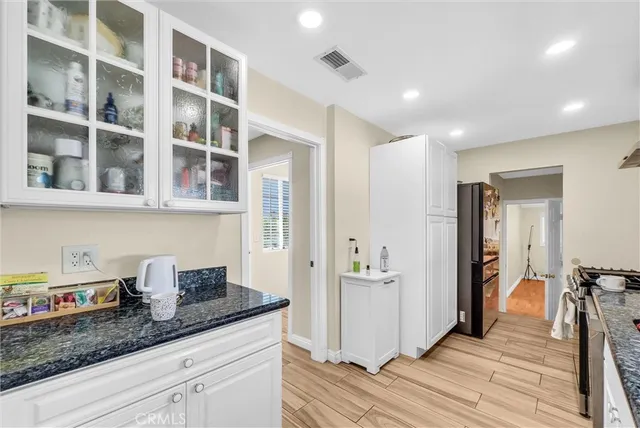 a hallway with cabinets and wooden floor