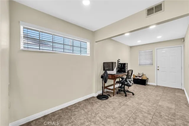 a view of a workspace with furniture and a window