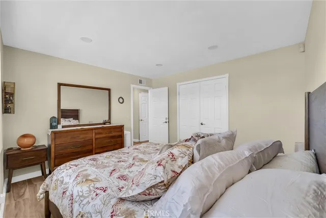 a bedroom with a bed and a dresser