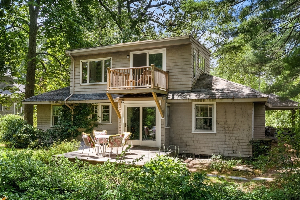 25 Duffield Road Newton, MA 02466 - Photo 18 of 19 a view of a house with a yard and lawn chairs next to a yard