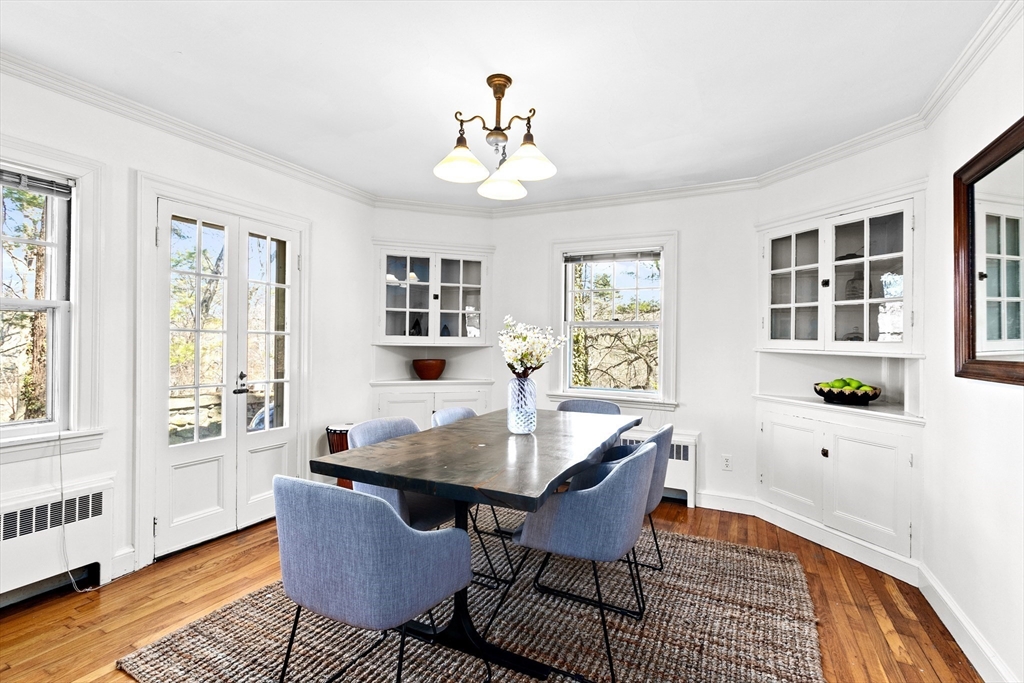 25 Duffield Road Newton, MA 02466 - Photo 5 of 19 a dining room with wooden floor a chandelier a wooden table and chairs