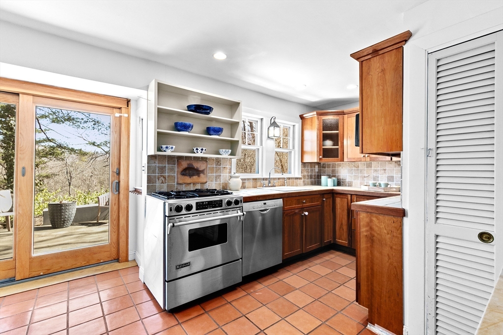 25 Duffield Road Newton, MA 02466 - Photo 6 of 19 a kitchen with stainless steel appliances granite countertop a stove a sink and a microwave
