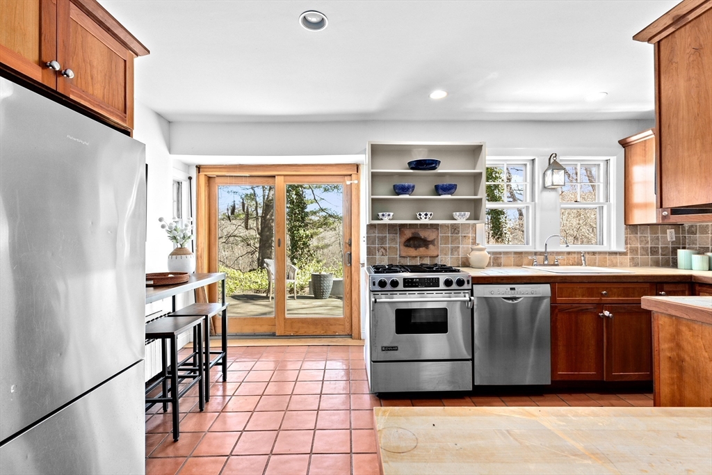 25 Duffield Road Newton, MA 02466 - Photo 7 of 19 a kitchen with stainless steel appliances granite countertop a stove and a refrigerator
