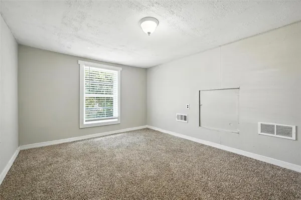 an empty room with a empty space and windows