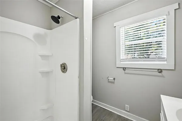 a bathroom with a sink a mirror and a shower