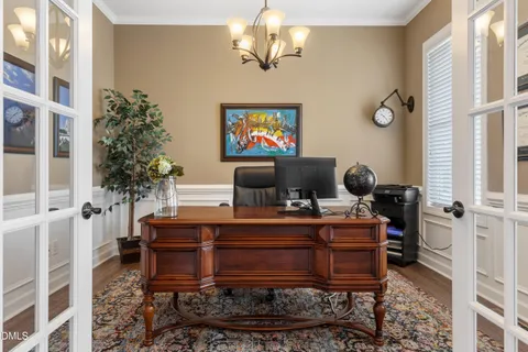 a view of a workspace with furniture and a chandelier
