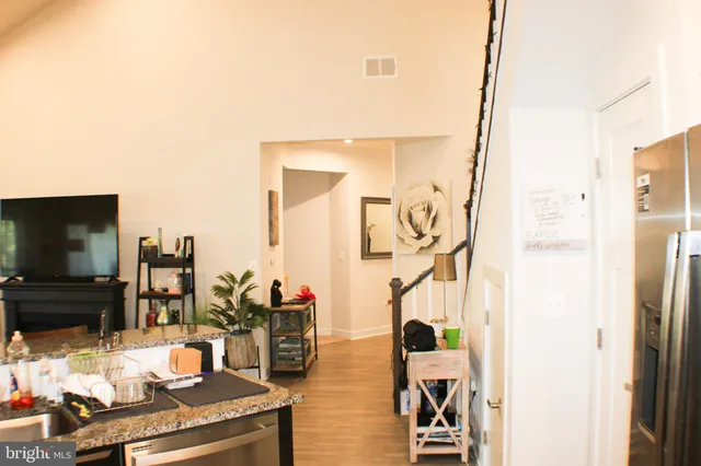 a view of a living room with furniture and a flat screen tv