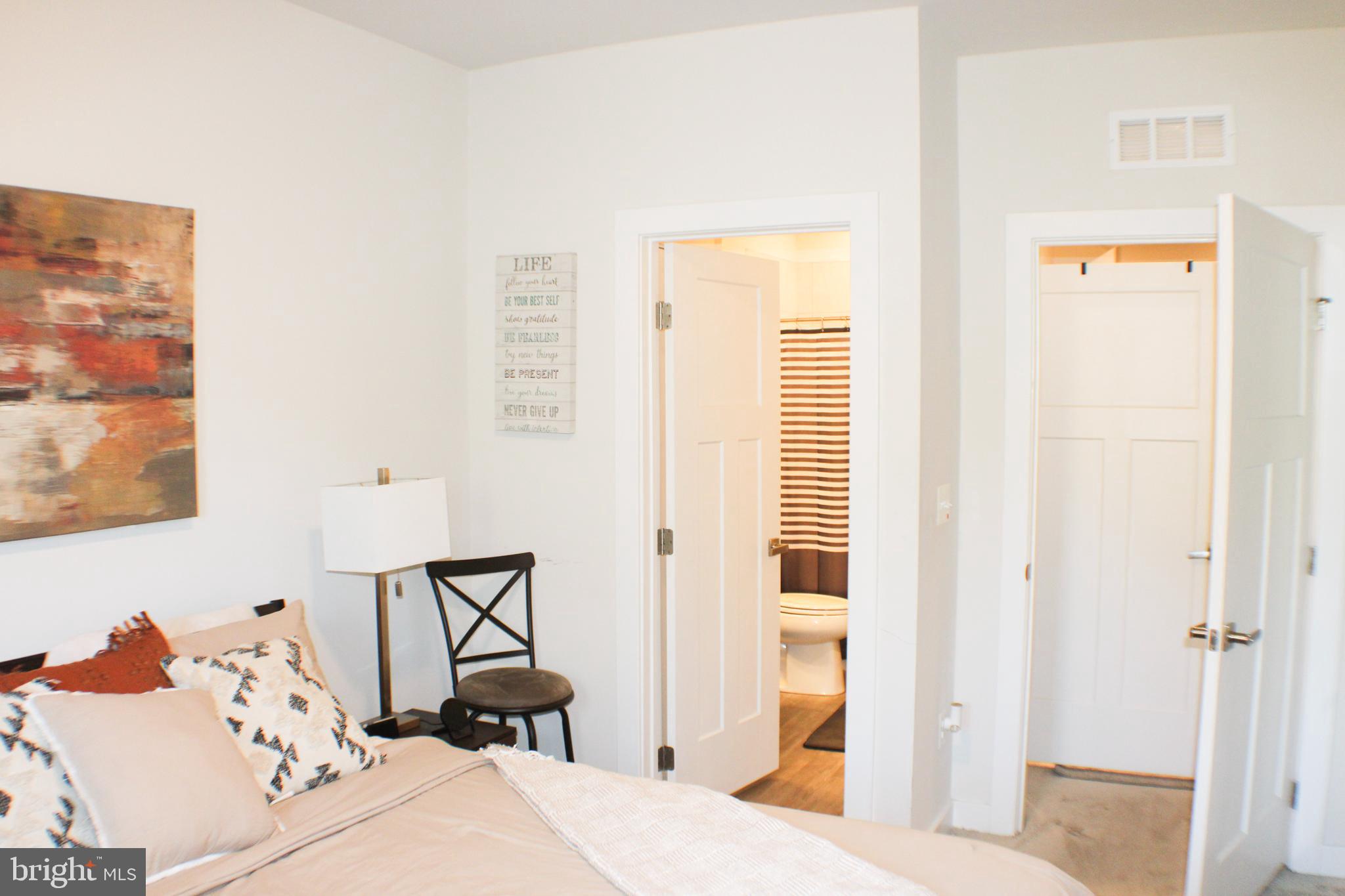 10120 Seattle Slew Lane, Unit P Laurel, MD 20723 - Photo 18 of 22 a bedroom with a bed and a window