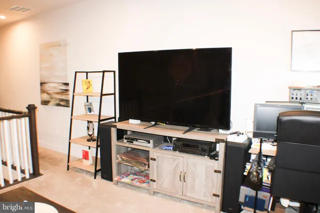 a living room with furniture and flat screen tv