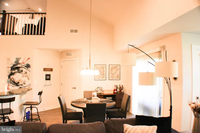 a dining room with furniture and wooden floor
