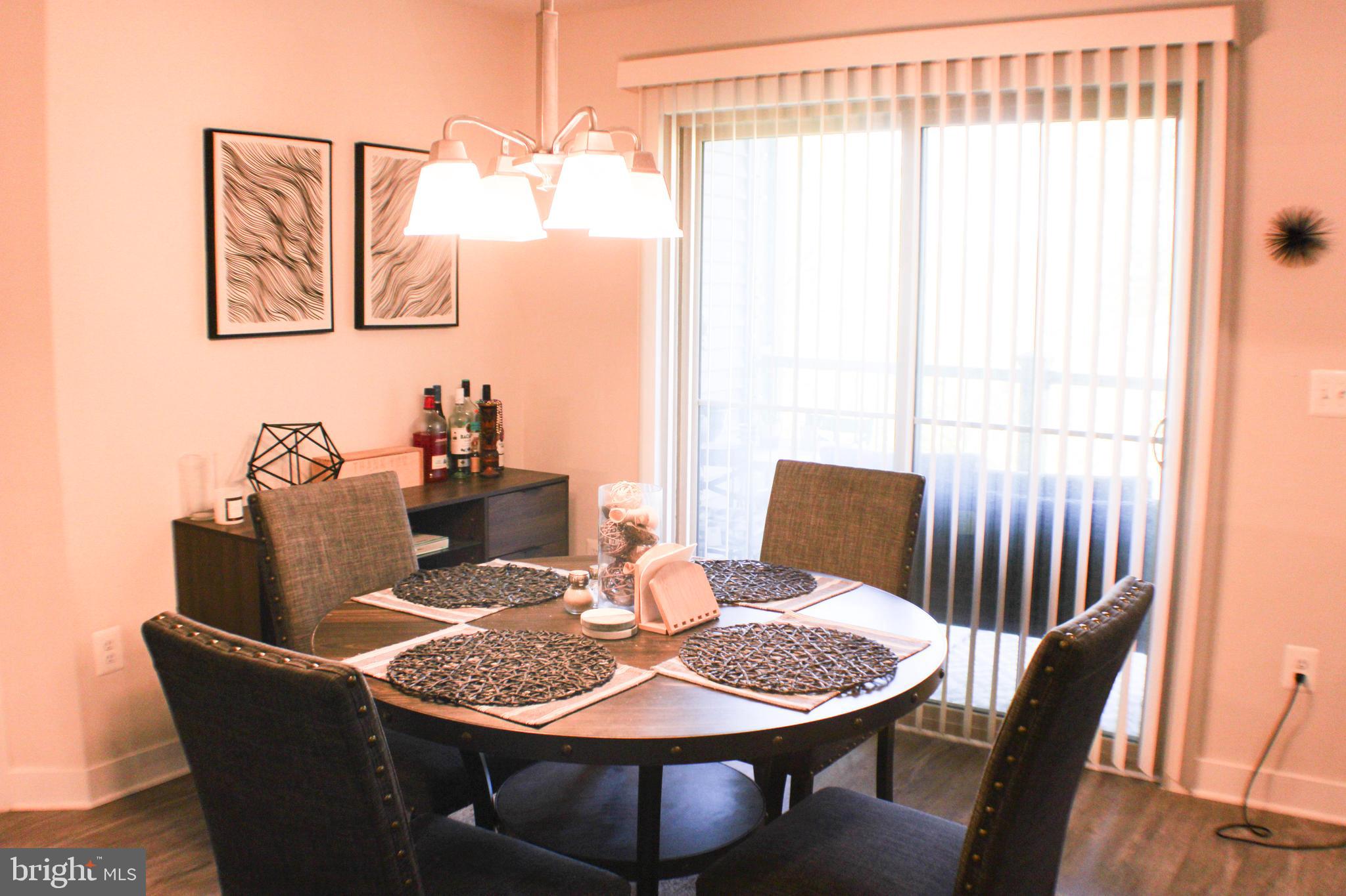 10120 Seattle Slew Lane, Unit P Laurel, MD 20723 - Photo 8 of 22 a view of a dining room with furniture window and wooden floor