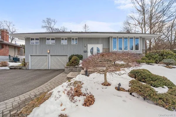 a view of a house with a yard covered in snow